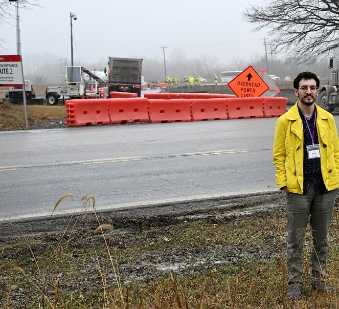 Sam Newhouse stands across from the Bauxite 2 data center construction entrance on Manor Woods Road in Adamstown
