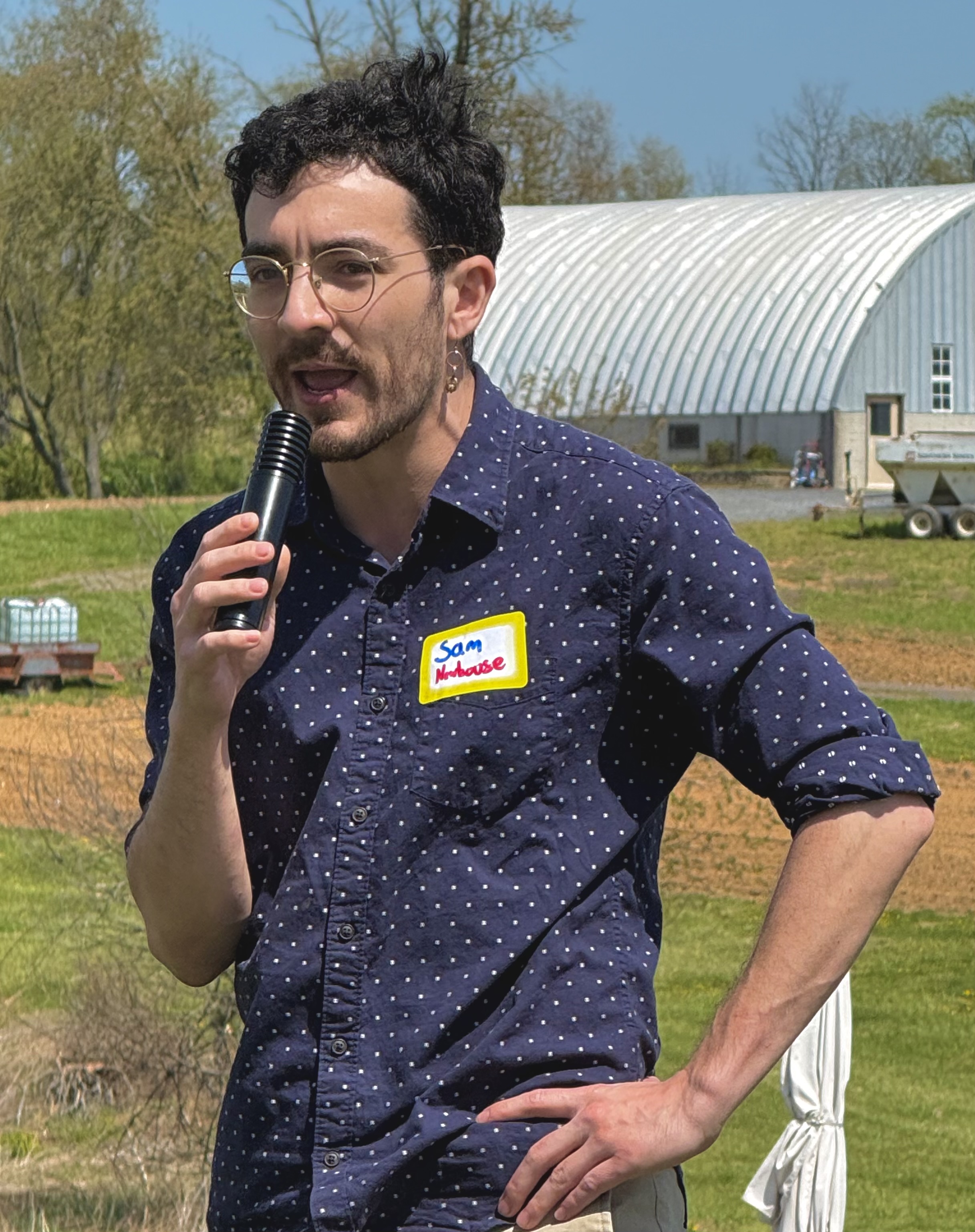 Sam Newhouse speaking at a community event on a Frederick County farm
